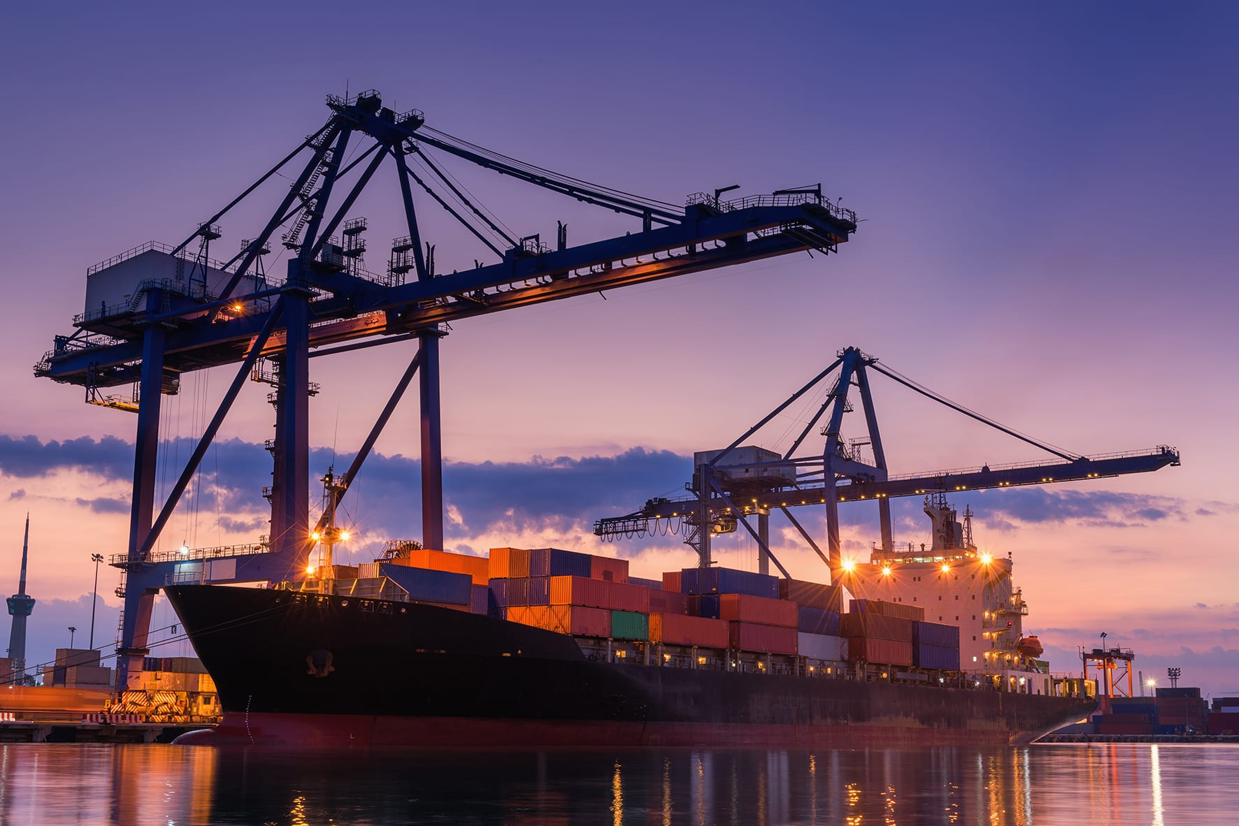 Container cranes over the quay at a working port